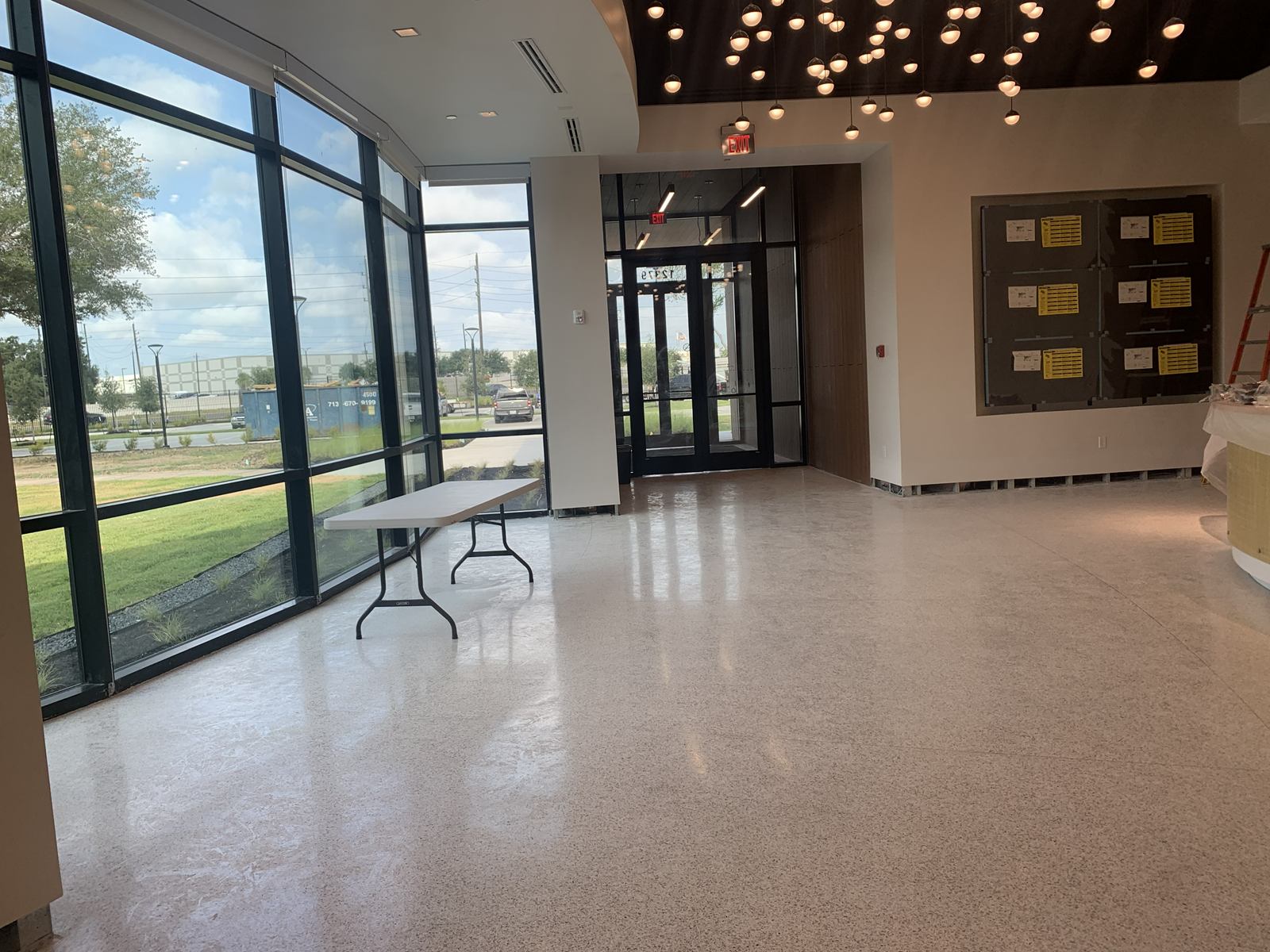 The lobby of the Eternal Gandhi Museum Houston, polished terrazzo floors and a glass wall, cleaned for opening day